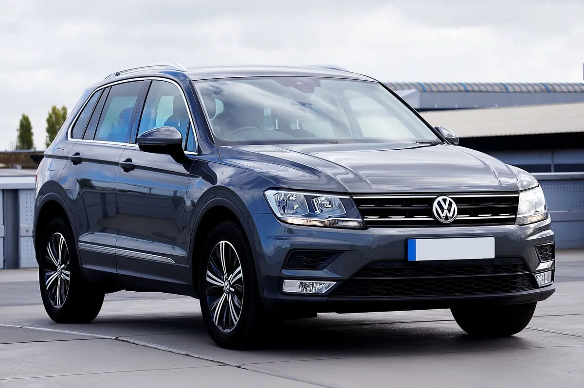 Grauer VW Tiguan schräg von vorn auf einem Parkplatz